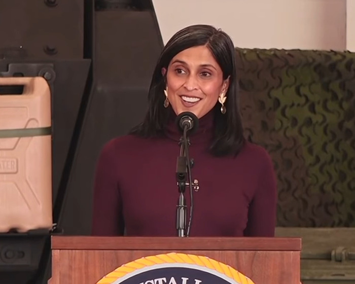 Usha Vance speaking at a podium addressing marriage split rumors after a ringless photo sparked an online meltdown.