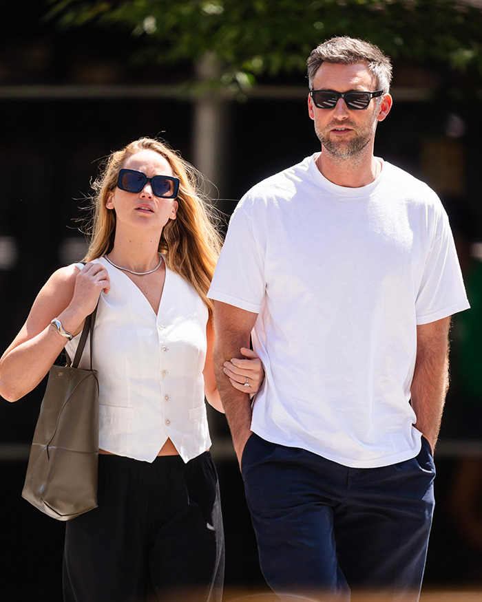 Jennifer Lawrence walking outdoors with a man, both wearing sunglasses, highlighting male co-stars and punishment claims. Jennifer Lawrence walking outdoors with a man, both wearing sunglasses, highlighting male co-stars and punishment claims.