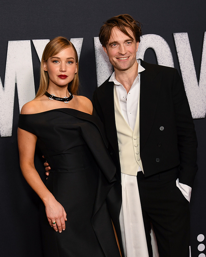 Jennifer Lawrence posing with a male co-star at a formal event, highlighting male co-stars and Jennifer Lawrence. Jennifer Lawrence posing with a male co-star at a formal event, highlighting male co-stars and Jennifer Lawrence.