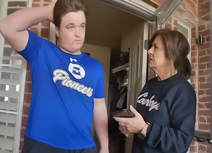 Teen and woman in tense conversation outside a brick house amid protests in Oklahoma over controversial legal case. Teen and woman in tense conversation outside a brick house amid protests in Oklahoma over controversial legal case.