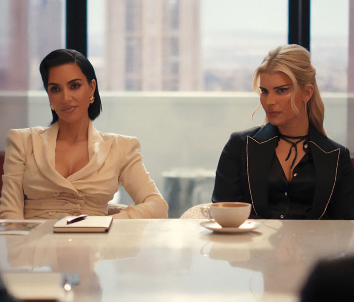 Two women seated at a conference table, highlighting Jessica Simpson's botched plastic surgery in her acting return role. Two women seated at a conference table, highlighting Jessica Simpson's botched plastic surgery in her acting return role.