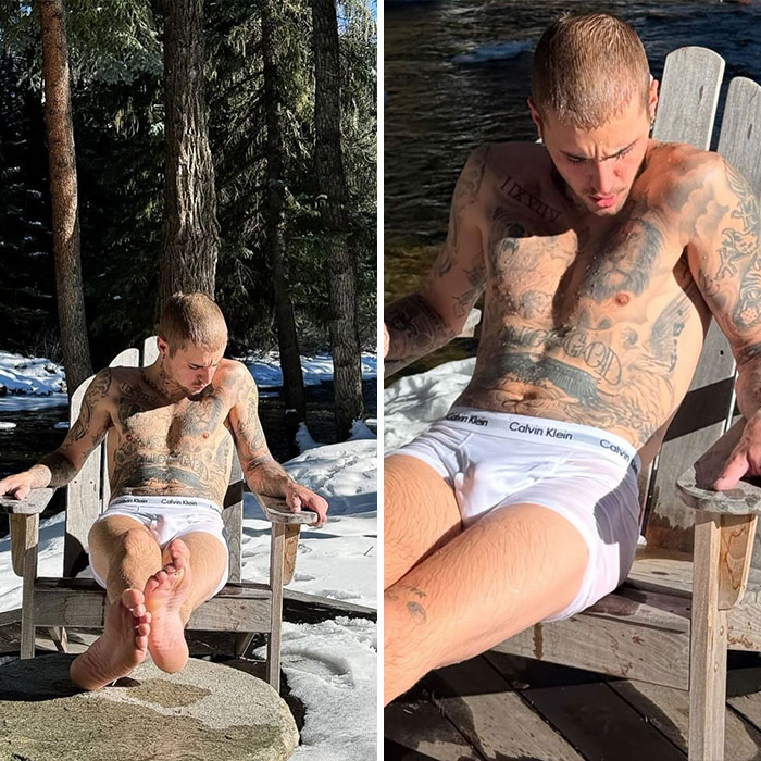 Tattooed man relaxing outdoors in Calvin Klein underwear, revealing more than usual, sparking celebrity frenzy in 2025.