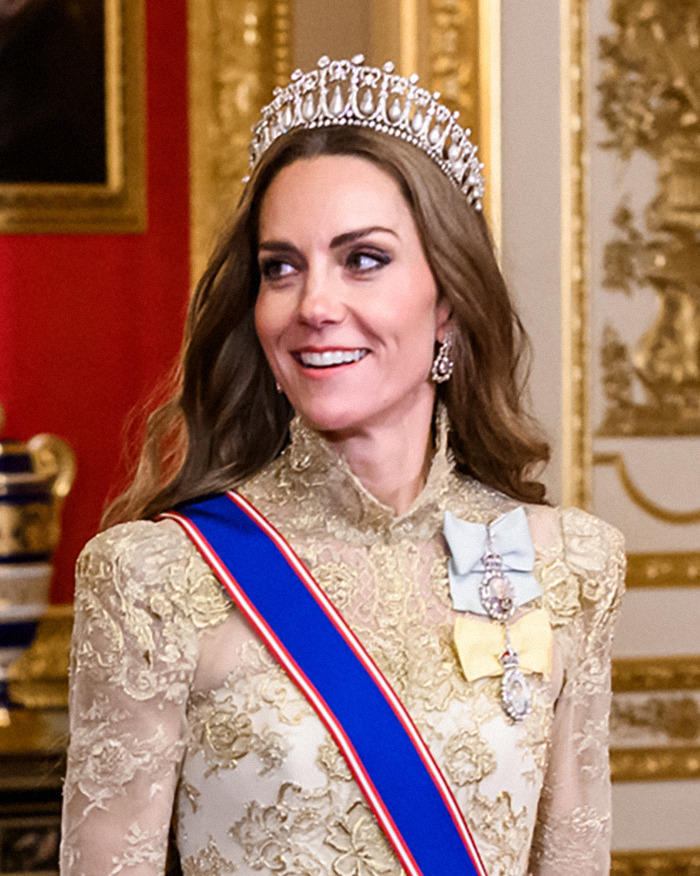 Kate Middleton smiling indoors wearing a tiara and a gold dress, her hair looking unnaturally healthy and blonde. Kate Middleton smiling indoors wearing a tiara and a gold dress, her hair looking unnaturally healthy and blonde.