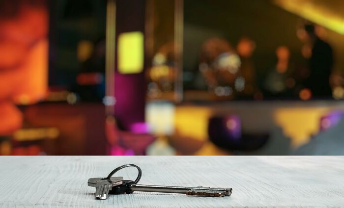 Set of old and new keys on a wooden surface with a blurred background, illustrating the theme of crazy coincidences.
