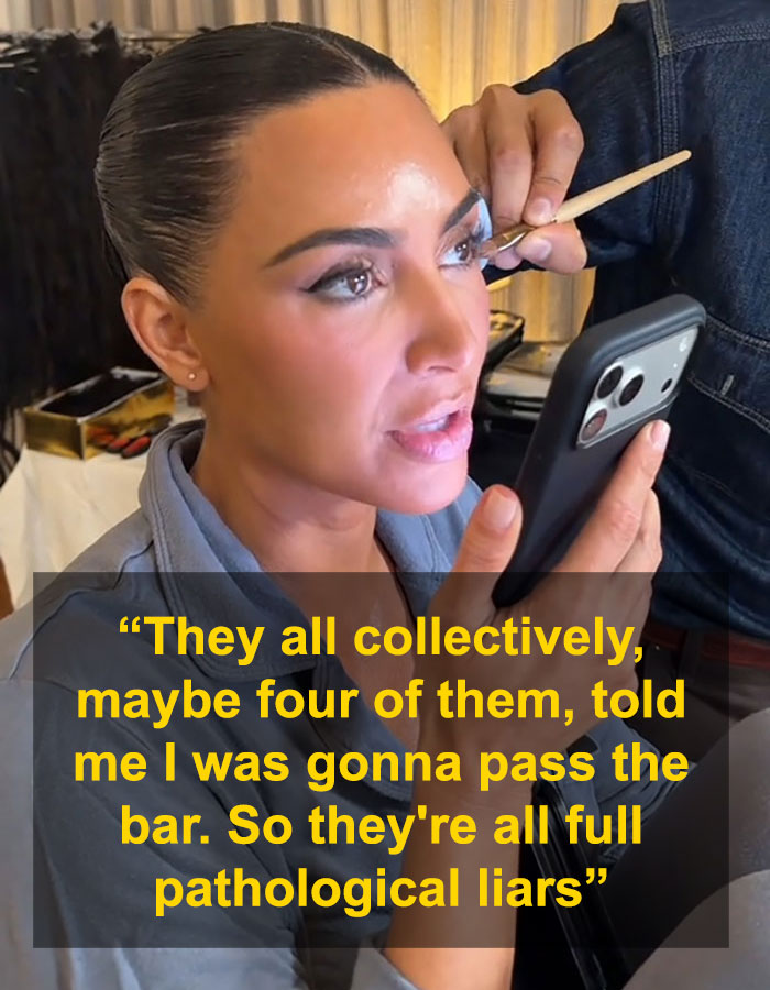 Kim Kardashian applying makeup while holding a phone, discussing pathological liars after failing the bar exam.