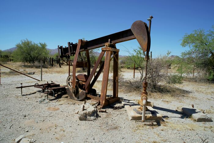 Rusty oil pumpjack in a desert landscape illustrating interesting laws and loopholes lawyers are sharing.