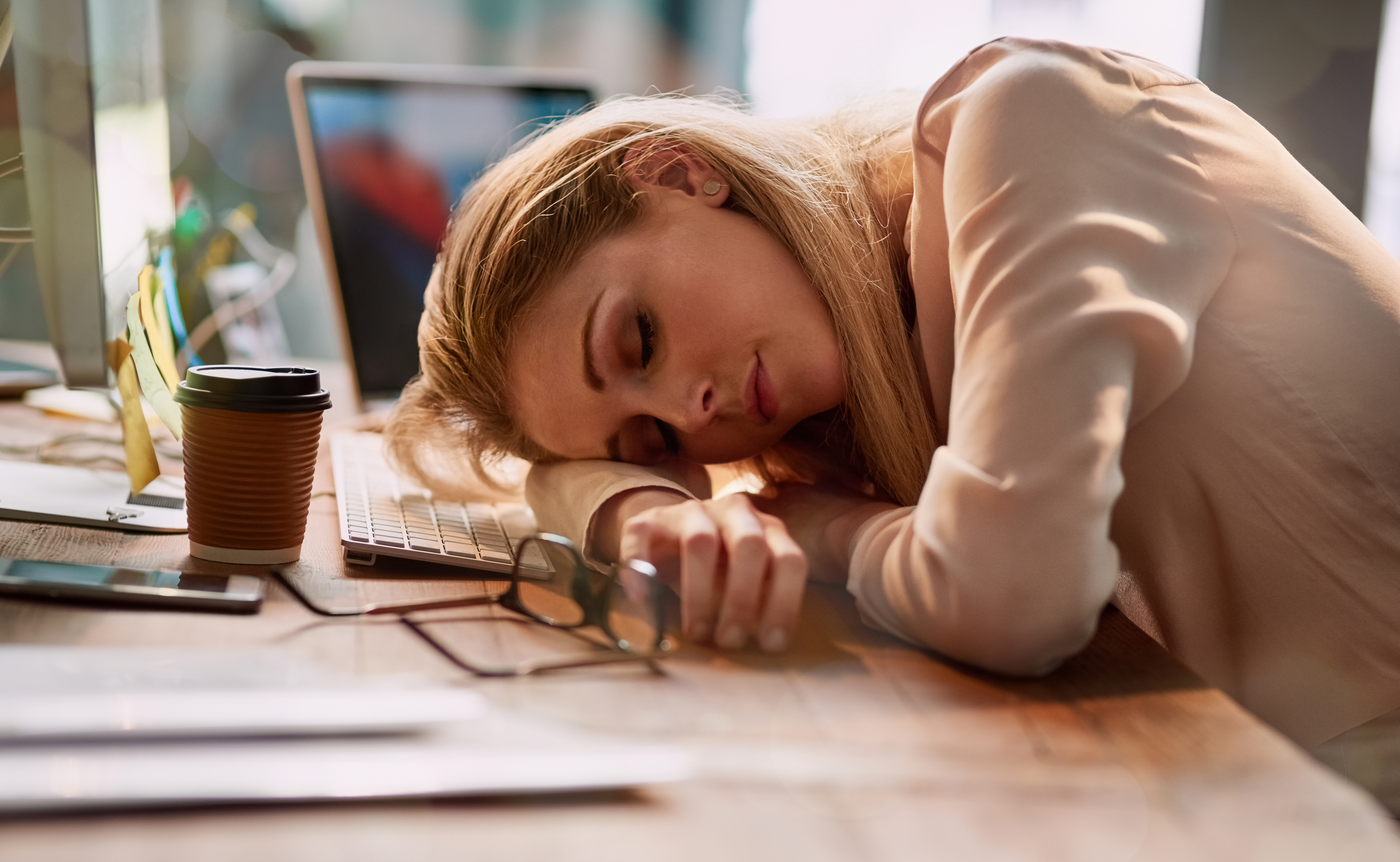 Woman exhausted and resting head on desk, showing effects of being treated like a servant and loss of attraction in relationship. Woman exhausted and resting head on desk, showing effects of being treated like a servant and loss of attraction in relationship.