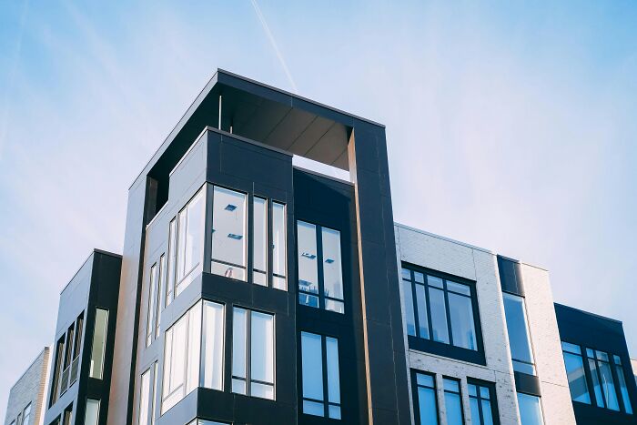 Modern apartment building exterior with large windows, symbolizing relationship challenges and testing trust in a partnership. Modern apartment building exterior with large windows, symbolizing relationship challenges and testing trust in a partnership.