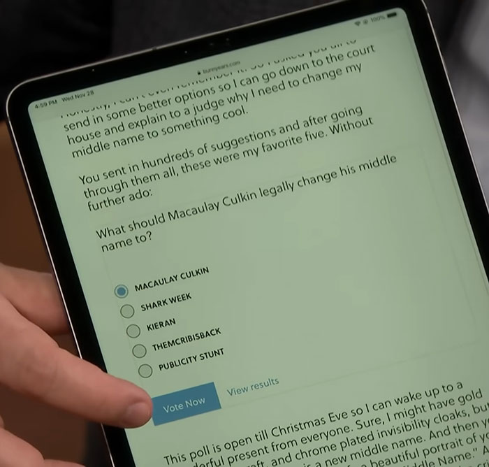 Person holding tablet showing a poll about Macaulay Culkin legally changing his middle name online. Person holding tablet showing a poll about Macaulay Culkin legally changing his middle name online.