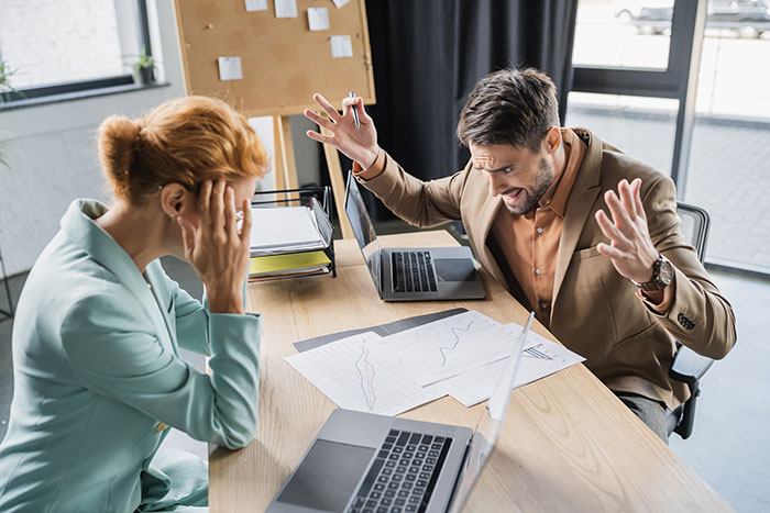 Manager and employee in office, manager frustrated as employee takes time off, expressing shock and disbelief. Manager and employee in office, manager frustrated as employee takes time off, expressing shock and disbelief.