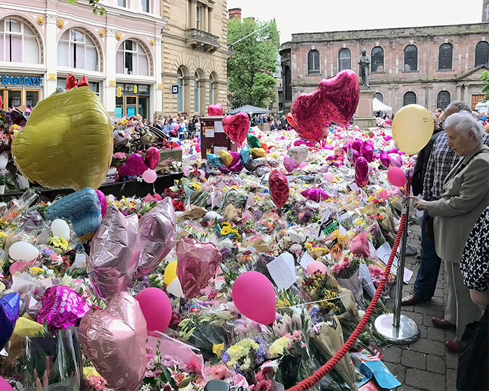 Crowd gathered around a memorial filled with flowers and balloons, reflecting the impact of Ariana Grande's last hurrah announcement. Crowd gathered around a memorial filled with flowers and balloons, reflecting the impact of Ariana Grande's last hurrah announcement.