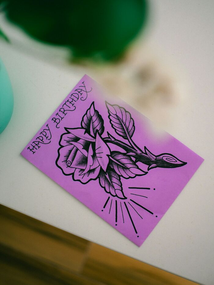 Purple birthday card with a black rose illustration, highlighting childhood habits that seem anything but normal.