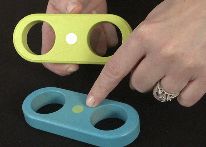 Hands holding and pointing at colorful objects with holes, illustrating dangerous things in everyday life for medical malpractice lawyer.