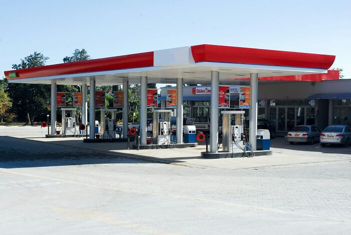 Empty gas station with multiple pumps under a red and white canopy, illustrating craziest coincidences people experienced.