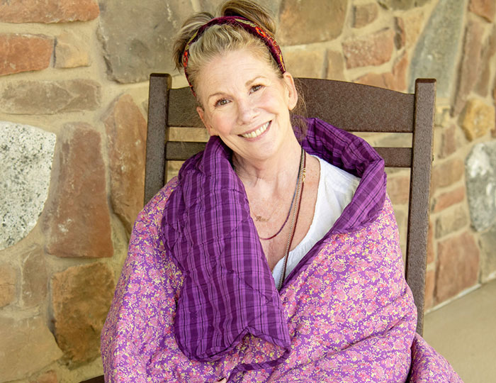 Melissa Gilbert wrapped in a purple blanket, smiling while reflecting on age gap with her on-screen husband. Melissa Gilbert wrapped in a purple blanket, smiling while reflecting on age gap with her on-screen husband.