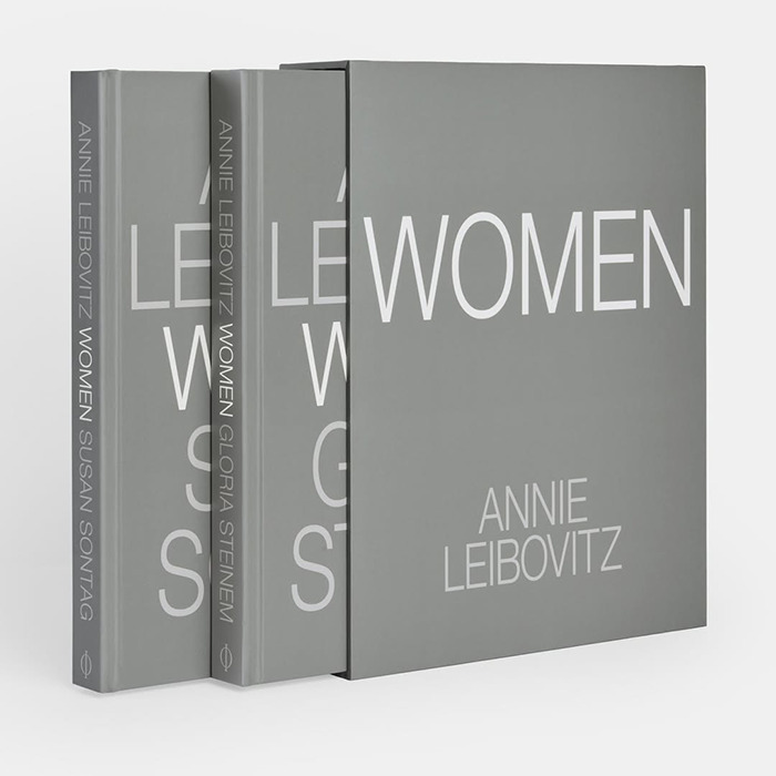 A set of Annie Leibovitz photography books titled Women with grey covers, stacked neatly on a white surface.