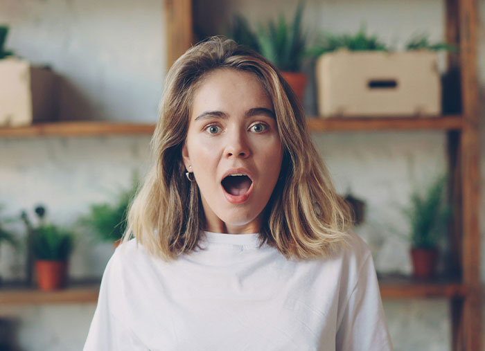 Bride shocked with mouth open, reacting to secret wedding invites and family image protection in a home setting. Bride shocked with mouth open, reacting to secret wedding invites and family image protection in a home setting.