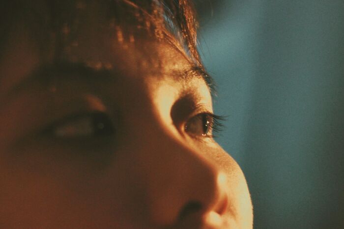 Close-up of a person's face showing emotion, capturing moments when folks wanted to say something funny but accidentally hurt loved ones.