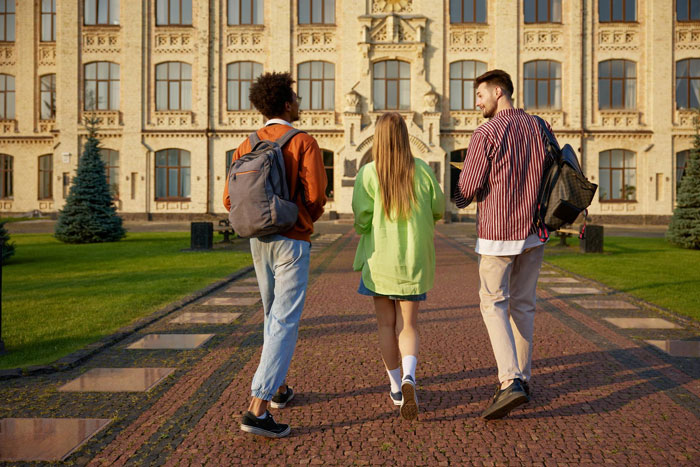 Three college students walking on campus, discussing money and family issues including mom affair and dad relationships. Three college students walking on campus, discussing money and family issues including mom affair and dad relationships.