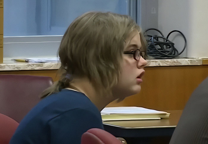 Young person wearing glasses in a courtroom setting related to Slender Man attacker captured after nationwide manhunt. Young person wearing glasses in a courtroom setting related to Slender Man attacker captured after nationwide manhunt.