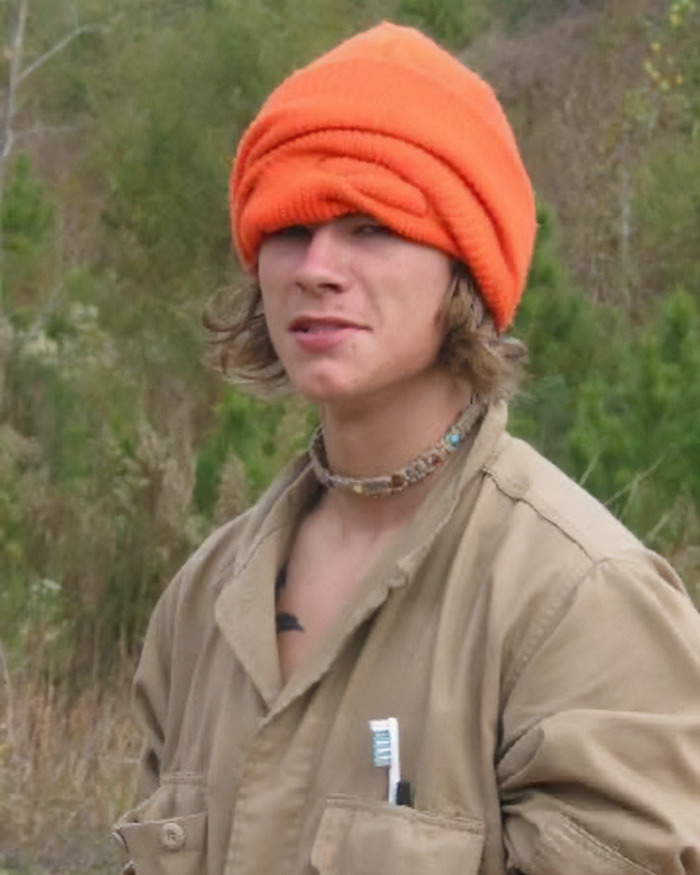 Young man wearing an orange beanie and beige jacket, related to Mom's stunning claim about skinned body in Las Vegas museum.