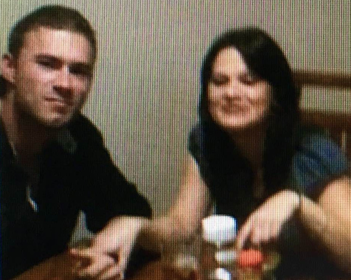 A woman and young man sitting at a table with drinks, related to mom’s claim about skinned body in Las Vegas museum.