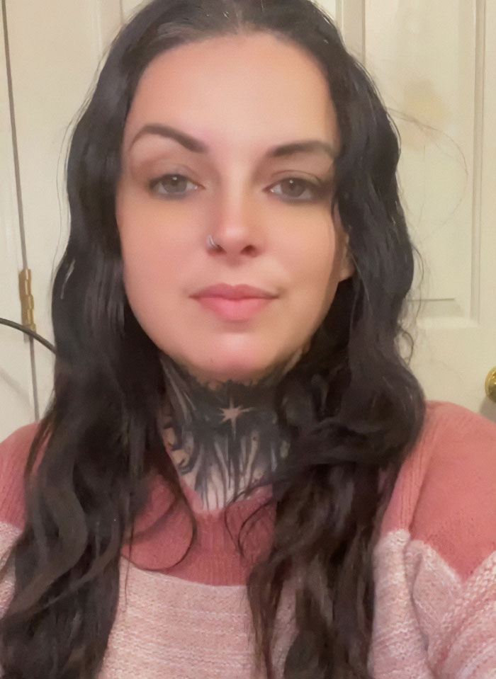 Woman with long dark hair and neck tattoo indoors, related to social experiment with US megachurches sparking online frenzy. Woman with long dark hair and neck tattoo indoors, related to social experiment with US megachurches sparking online frenzy.