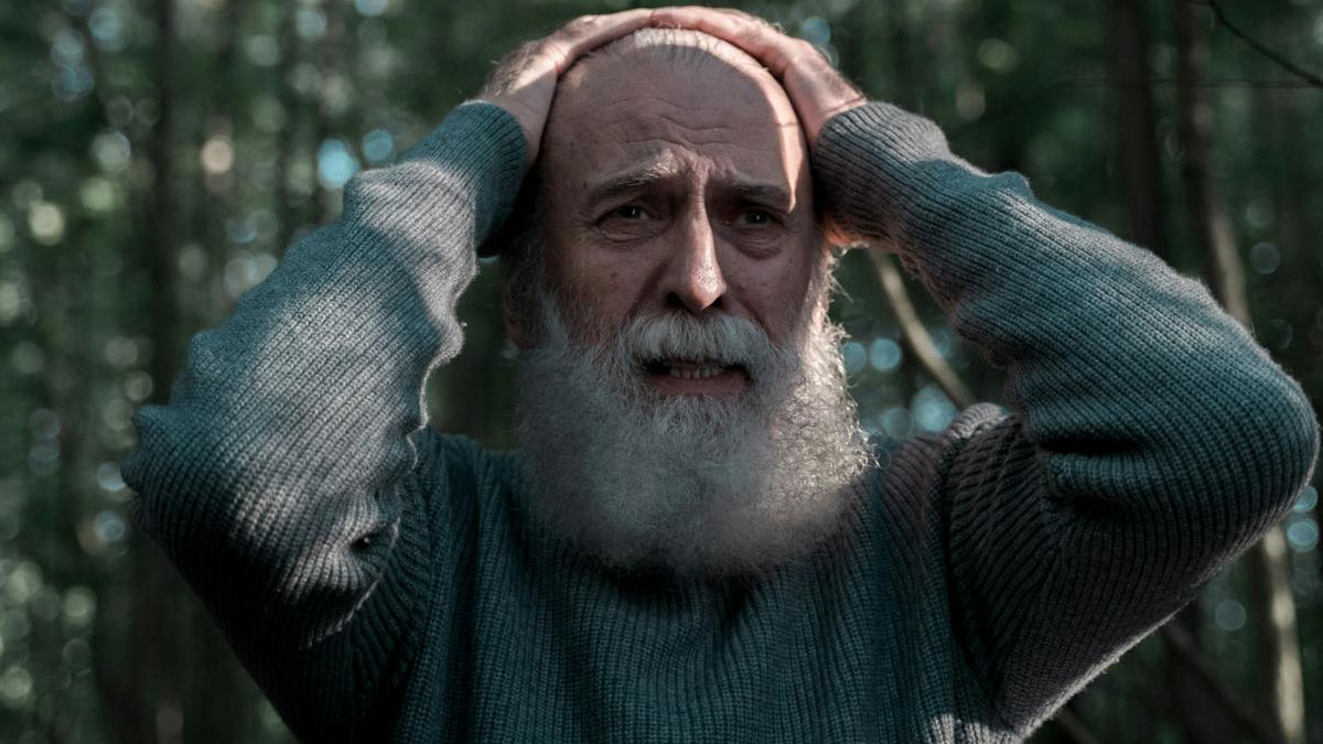 Elderly man with white beard holding his head in distress, representing intense psych ward nurse stories.