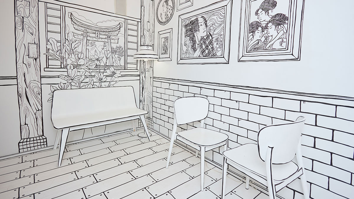 Interior of a 2D restaurant in NYC with black and white line art walls and furniture resembling a drawing.