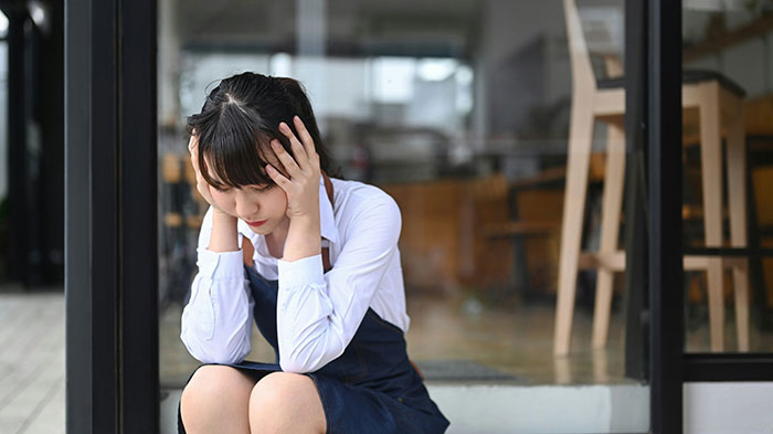 Teen girl sitting outside looking upset and stressed, illustrating parents trying to cure depression by removing her mattress. Teen girl sitting outside looking upset and stressed, illustrating parents trying to cure depression by removing her mattress.