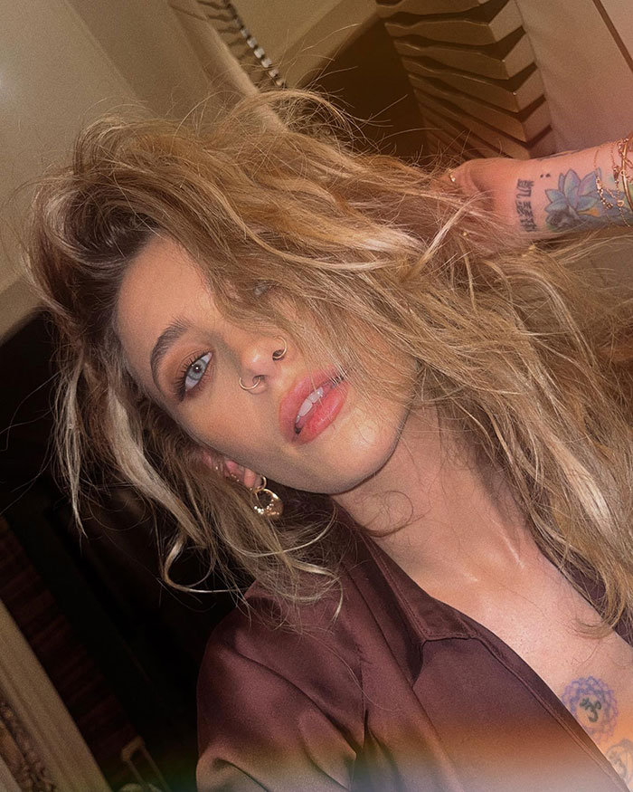 Paris Jackson with tousled hair and visible tattoos, sharing her experience of substance use deforming her face. Paris Jackson with tousled hair and visible tattoos, sharing her experience of substance use deforming her face.