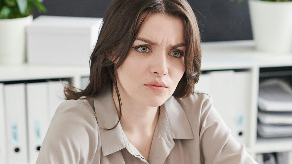 Woman with a frustrated expression in an office setting, illustrating stories about why some folks donu2019t deserve nice things.