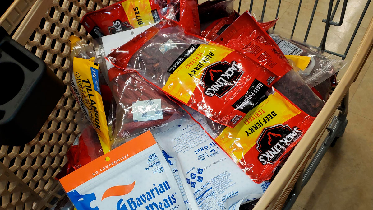 Shopping cart filled with various meat products showing a lucrative loophole exploited unapologetically.
