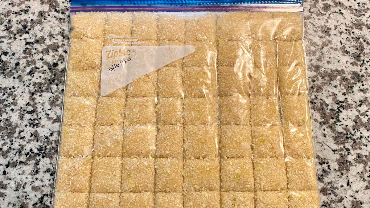 Ziploc bag of pre-cut dough squares on granite countertop, illustrating kitchen tips for easier cooking prep.
