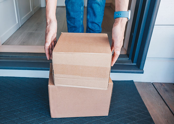 Person receiving wrong packages at doorstep, dealing with company expecting return shipping at his own expense.