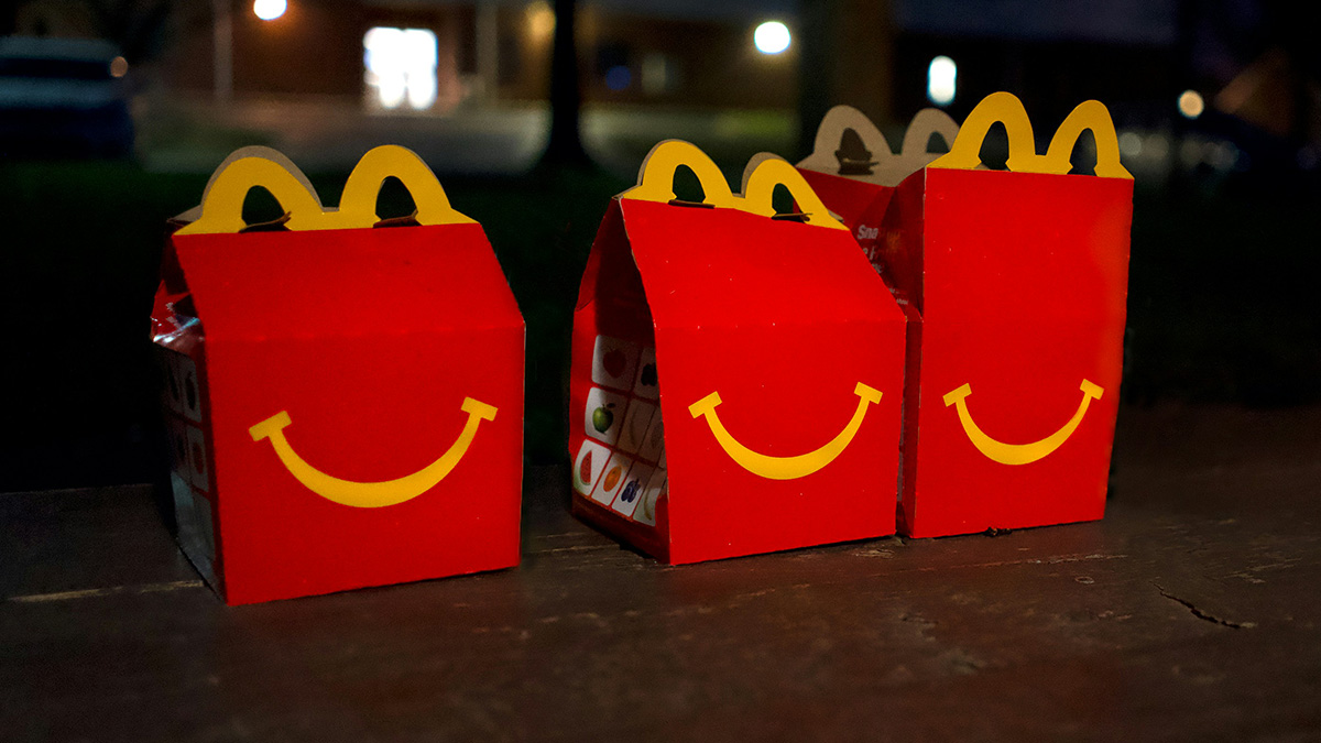 Red Happy Meal boxes on a wooden surface at night, symbolizing a special meal for bride's revenge on controlling MIL.