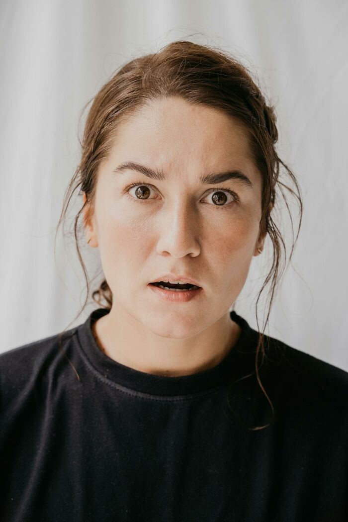 Woman with a shocked expression, realizing parenting moments that hint they may be raising monsters.