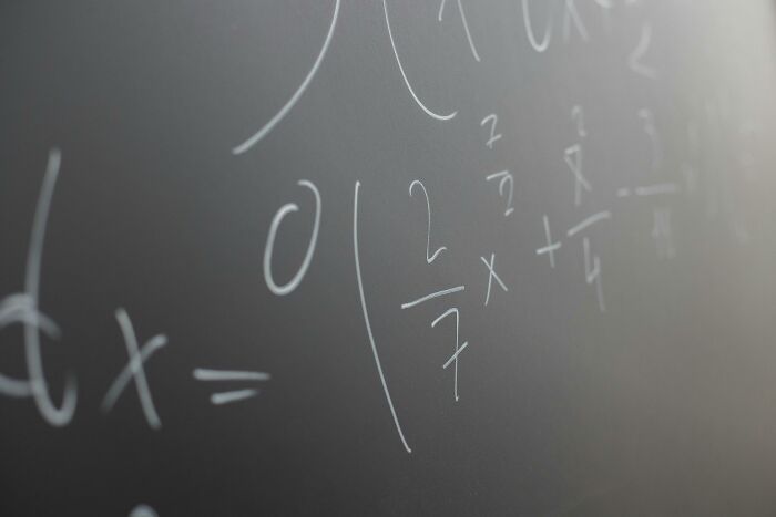 Close-up of complex math equations on a chalkboard representing challenges of all 12 grades of math quiz. Close-up of complex math equations on a chalkboard representing challenges of all 12 grades of math quiz.