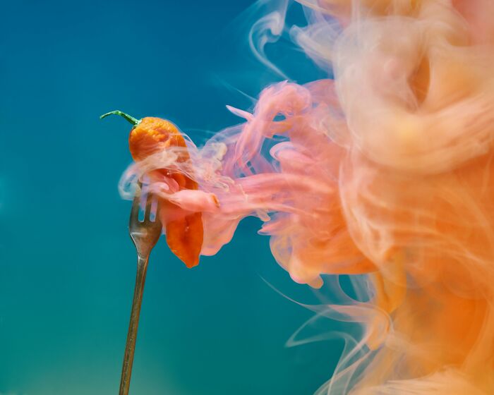 Orange hot chili pepper on a fork emitting swirling smoke, representing visual thinkers in odd-one-out questions. Orange hot chili pepper on a fork emitting swirling smoke, representing visual thinkers in odd-one-out questions.