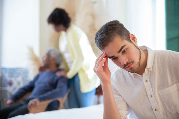 Young man looking worried and hiding while making a desperate call about newlywed issues on a radio show. Young man looking worried and hiding while making a desperate call about newlywed issues on a radio show.