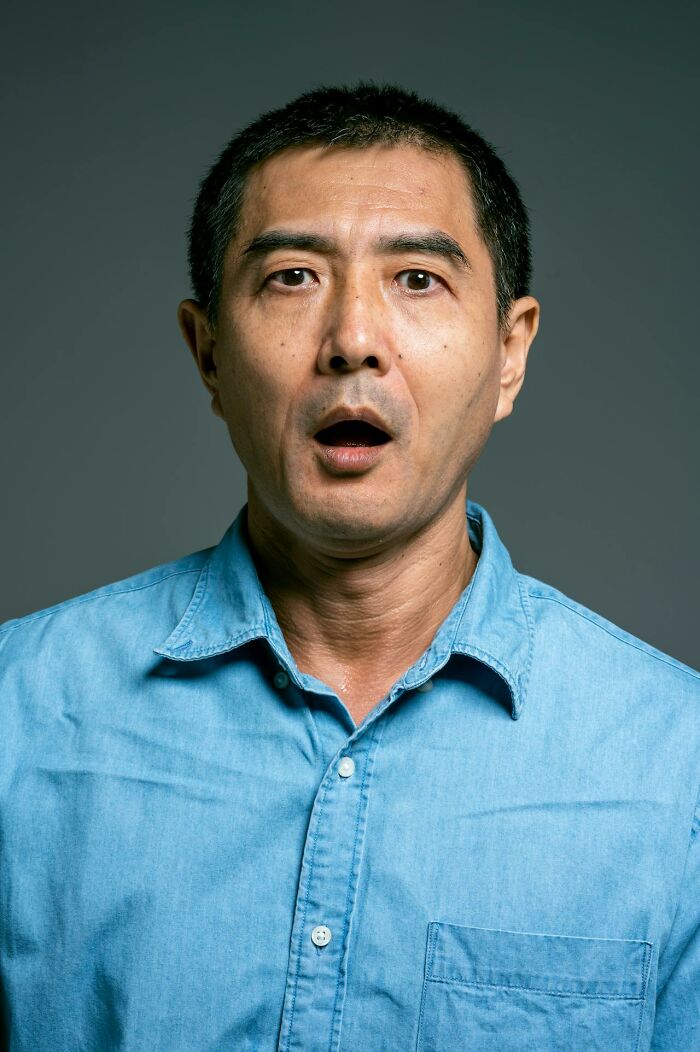 Middle-aged man in a blue shirt with a surprised expression, illustrating bizarre moments confusing sanity.