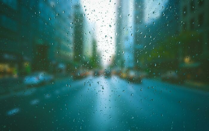 Raindrops on window with blurred city street background, challenging viewers to identify objects and test visual IQ. Raindrops on window with blurred city street background, challenging viewers to identify objects and test visual IQ.
