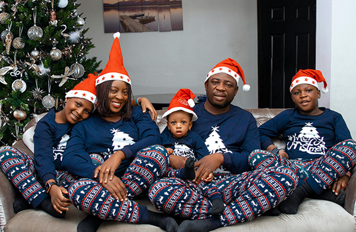 Family wearing matching Christmas pajamas and Santa hats, highlighting expose the cheaters and family secrets theme. Family wearing matching Christmas pajamas and Santa hats, highlighting expose the cheaters and family secrets theme.