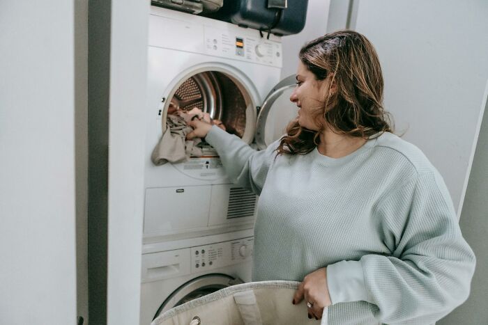 Woman doing laundry at home, representing lady regrets marrying man with kids and parenting every weekend challenges Woman doing laundry at home, representing lady regrets marrying man with kids and parenting every weekend challenges
