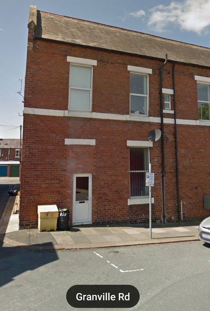 Brick building with a door missing a sidewalk step, illustrating a design and architecture nightmare on Granville Rd.