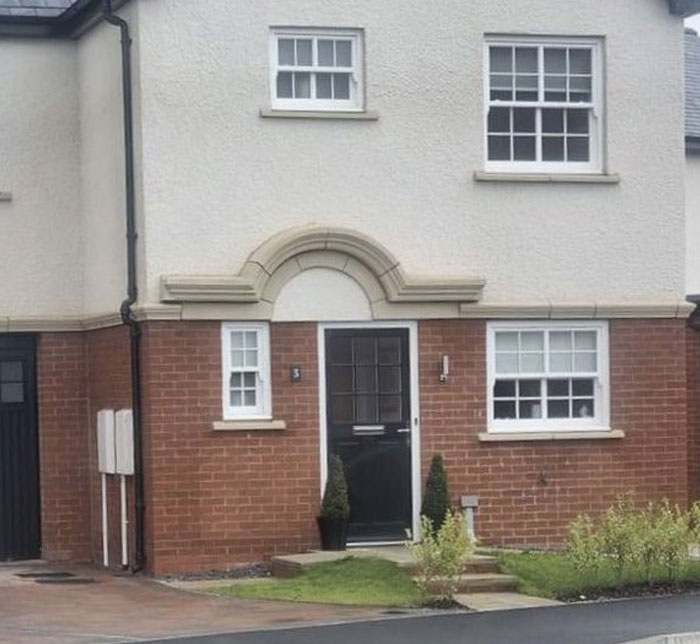 House exterior with mismatched window sizes and awkward architectural design, illustrating design and architecture nightmares.