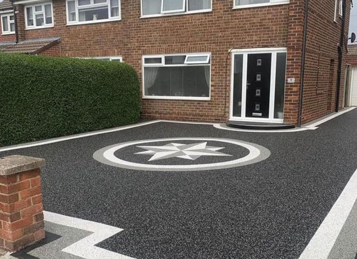 Driveway design with confusing compass rose and impractical door steps showcasing design and architecture nightmares.