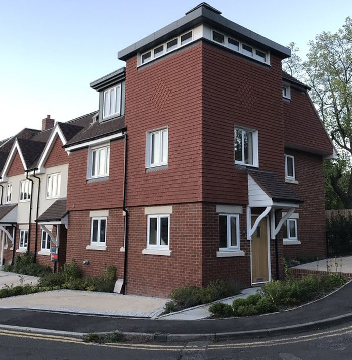 Corner house with unusual window placements and awkward design illustrating design and architecture nightmares.
