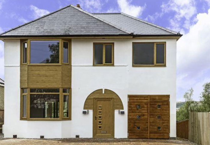 Modern house exterior with unusual wooden design and architecture elements creating a design and architecture nightmare.