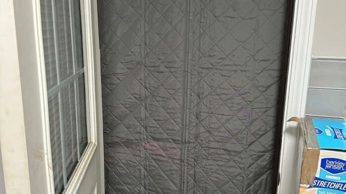 Door covered with insulated curtain to prepare home for a cozy and worry-free winter season.